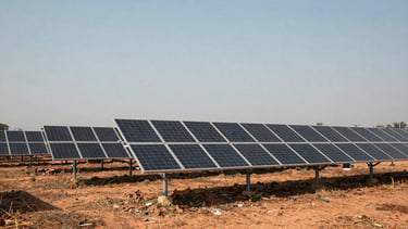A wide shot of a newly constructed solar farm in rural southern India, expansive sky, realistic saturated tones.
