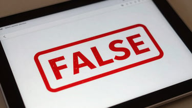 A close-up of a digital tablet displaying a social media post with a red FALSE stamp overlaid, clean professional lighting.