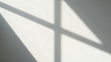 Abstract geometric shadow-play on a white gallery wall, sharp architectural lines, soft diffused daylight, high contrast, 35mm