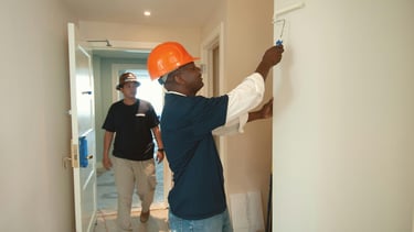 Worker painting the inside of a home.