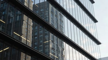 Abstract photography of light reflecting on glass and metal surfaces in a futuristic office building, evoking innovation and high-tech quality.