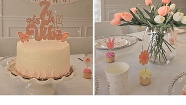 Elegant boho pink birthday party decorations featuring a custom cake, balloons, and floral table setting.