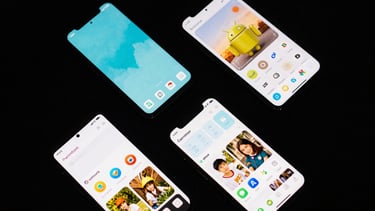 Overhead flat-lay of four Android phones arranged in a tight grid, each displaying a different app interface at high magnification under controlled studio lighting, screens sharp and vivid against a near-black matte surface