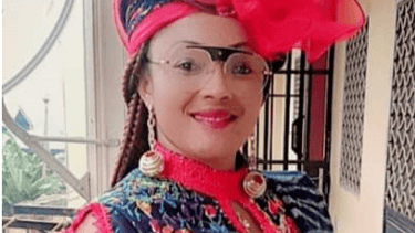 a woman in a colorful dress and a red hat