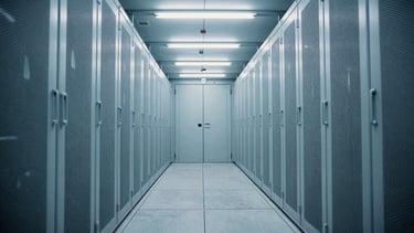 Symmetrical view down a long, empty high-security server corridor, cold white fluorescent lighting, polished concrete floors, extreme depth, no human presence, 35mm