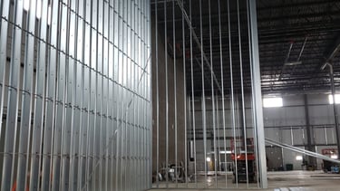 Interior steel stud framing installed for commercial construction prior to drywall and ceiling insta