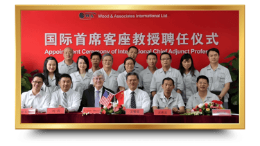 a group of people standing around a table with a flag