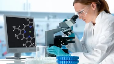 A female scientist in a white lab coat studies DNA in a microscope