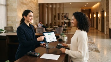 A modern hotel reception desk with a tablet displaying a clean PMS dashboard, warm architectural lighting, professional hospitality interior, 35mm photography