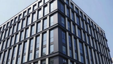 Wide-angle environmental shot of a secured modern commercial building, clean architectural detail, crisp daylight, 35mm