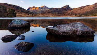 Scenic view of the Langdale Pikes reflected in the calm waters of Blea Tarn, Lake District.