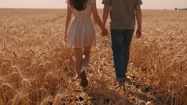 Cinematic wide shot of a couple walking hand-in-hand through a sun-drenched golden wheat field, backlighting, warm terracotta tones, 35mm film