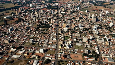 Panoramic satellite-style aerial map view of the Brasília metropolitan region and Entorno do DF in central Brazil, showing road network and urban clusters around Valparaíso de Goiás, Luziânia, Novo Gama and Gama, natural daylight, slightly desaturated cartographic tone