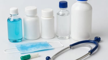 Close-up of hands handling medical devices and supplements during a workshop.