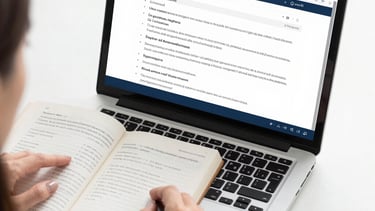 A healthcare professional reviewing detailed medical charts with a focused expression