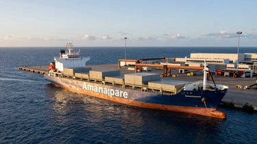 Wide panoramic shot of Port of Amamapare, cargo ships docked at a modern industrial terminal, deep blue ocean, golden hour lighting, clean composition
