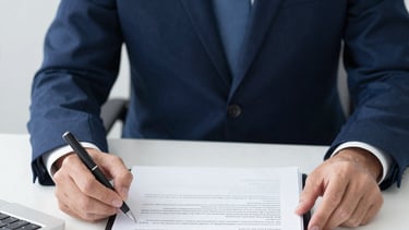 Professional handshake between an international manufacturer and a U.S. regulatory consultant.