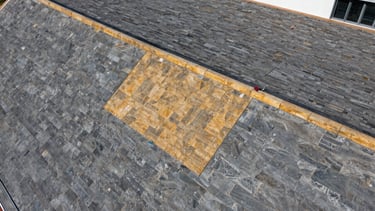 Drone view of a high-resolution roof assessment scan, sharp detail, high-contrast slate and amber tones.