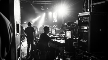 sound engineers and production backstage crew during a live event.