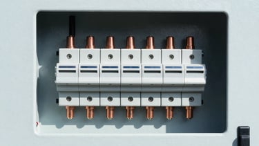 High-contrast macro shot of a newly installed commercial electrical distribution panel, crisp daylight, copper components visible, perfectly aligned, 35mm architectural photography