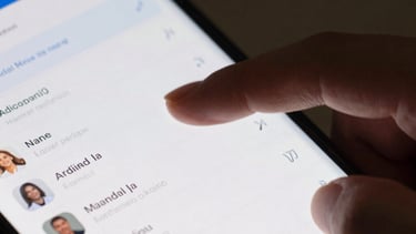Detailed photography of a person's thumb scrolling through a sleek Android app list. Dynamic motion blur, emphasizing speed and responsiveness. Platinum and Oxford Blue colors.