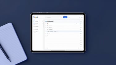Overhead workspace with a tablet displaying a clean Google AppSheet interface, neat wireframe notebook, cool studio lighting with electric blue highlights.