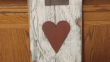 Rustic vertical wooden LOVE sign with distressed white paint, a burlap bow, and a red heart.