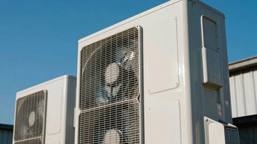 An outdoor commercial air conditioner unit with high-velocity exhaust fans spinning rapidly on a clear deep blue sky day, symbolizing powerful modern ventilation.
