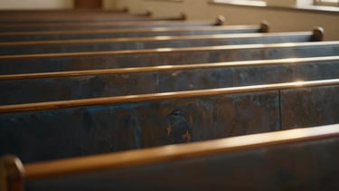 Warm golden light illuminating empty wooden pews in a simple sanctuary, soft peaceful atmosphere