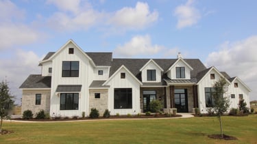 Large white modern farmhouse custom home exterior in DeKalb County, built by Built to Last