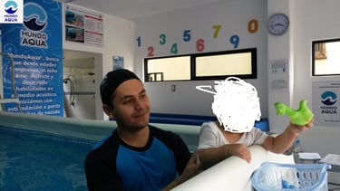 a man holding a green frog toy in front of a pool