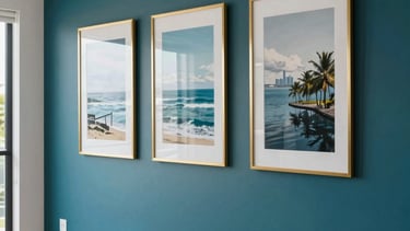 A detailed professional photograph of a luxury Auckland residential interior, showing a freshly painted feature wall in a deep teal color. The room is modern and bright, with gold-framed art and clean white trim, reflecting premium trade quality. The lighting is soft and natural, Oceanic style.