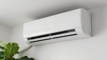 A close-up photograph of a modern air conditioning unit installed professionally on a clean white wall in a Central European home, soft natural light, vibrant green leaves of a houseplant in the corner for a touch of freshness.