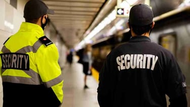 Security guards are stationed at the metro station, monitoring the platform.