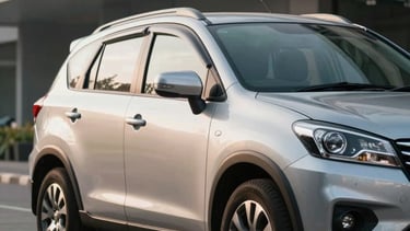 A high-quality professional photograph of a silver Suzuki XL7 parked in a modern minimalist Southeast Asian / Indonesian urban setting. The lighting is soft morning sunlight, emphasizing the vehicle's curves and white and light blue sky reflections on the windows.
