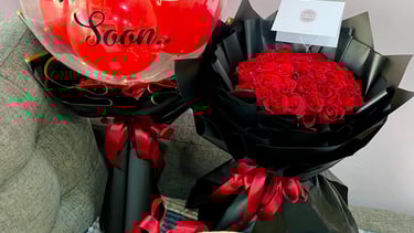 a basket of roses and a balloon - shaped balloon