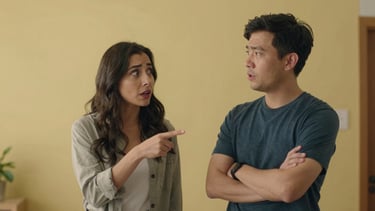 Medium shot of two animated characters mid-argument — one pointing, one crossing arms, both with exaggerated but clearly readable facial expressions. Bright indoor scene, flat even lighting, warm yellow walls behind them.