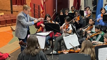String Orchestra Director in rehearsal.