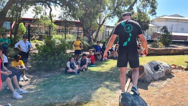 a man standing on a log in a park coaching