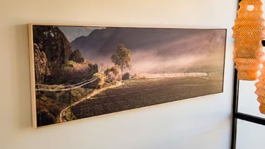 A large panoramic painting of a rural landscape in a modern interior painted by Martin Osner