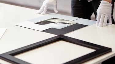 Professional artwork framing in progress at Osner Framing Studio, using archival materials.