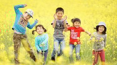 5 kids jumping in the yellow field
