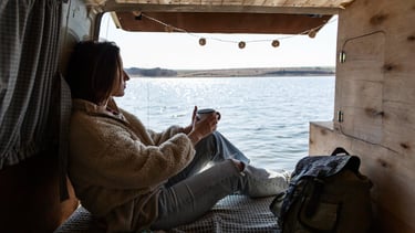 girl in campervan drinking coffe
