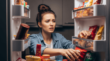 a woman is looking at the camera while she is looking at the food in the