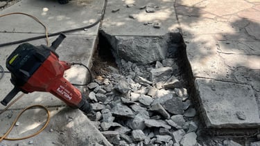 A jack hammer and broken up concrete patio Light demolition of