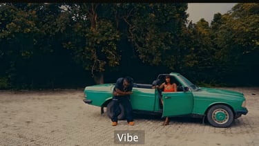 EazyKayy a man and woman in a red dress sitting in a green car