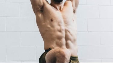 Fit Male Athlete about to have a massage and doing mobility test