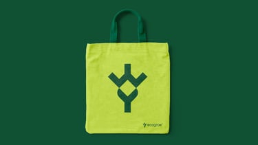 Green tote bag design with geometric leaf logo.