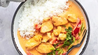 thm recipe coconut curry in bowl help by a woman's hands
