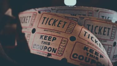 A roll of vintage raffle tickets with keep this coupon text for a retro movie theater or event.